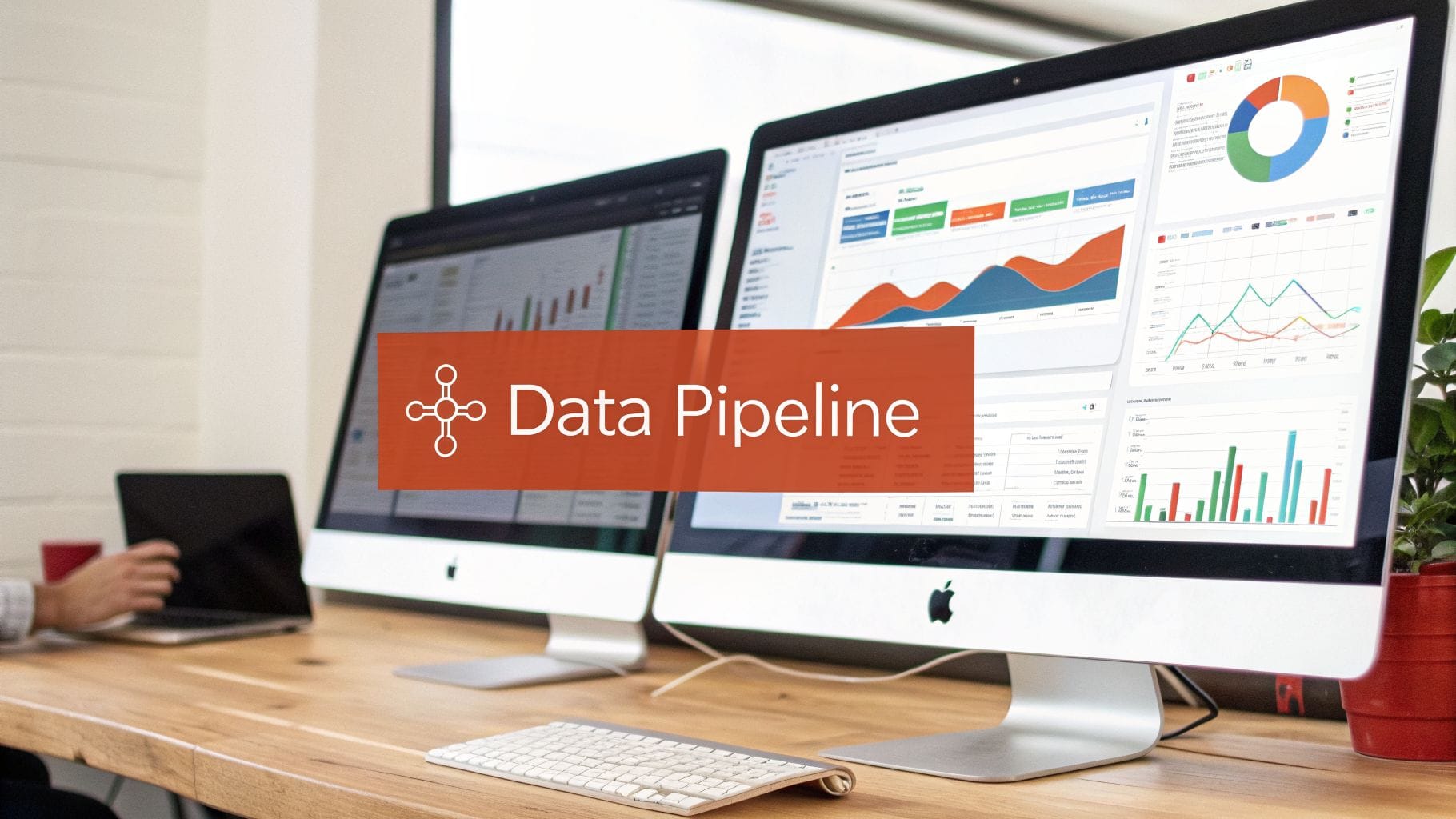 Two computer monitors display data visualizations and charts on a wooden desk with a 'Data Pipeline' banner.